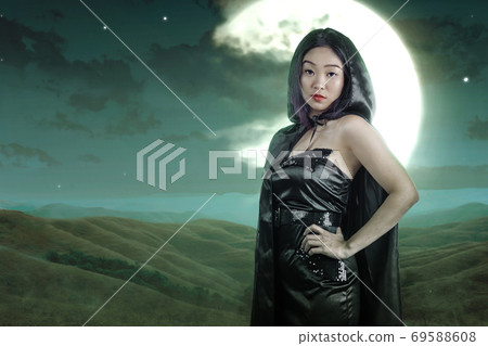 Asian witch woman with cloak standing Asian witch woman with cloak standing 69588608