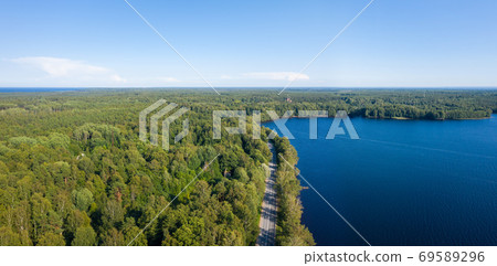 Asphalt freeway through summer forest near lake 69589296