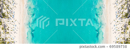 Aerial view from drone on caribbean seashore with coconut palm trees and sunbeds. Summer holidays Aerial view from drone on caribbean seashore with coconut palm trees and sunbeds. Summer holidays 69589738