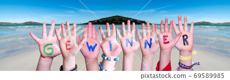 Children Hands Building Word Gewinner Means Winner, Ocean Background 69589985