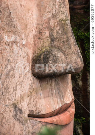 Close up of majestic Giant Leshan Buddha lips and nose Close up of majestic Giant Leshan Buddha lips and nose 69592077