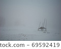 Shelter in the fog on a snowy meadow. Winter. Dusk on the polonyna Svynianka, outskirts of a Mykulychyn, Ukrainian Carpathians 69592419