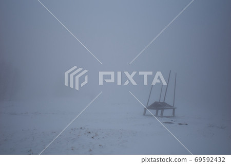 Dusk fog shelter. Surreal mystery atmosphere on the alpine meadow Dusk fog shelter. Surreal mystery atmosphere on the alpine meadow 69592432