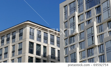 Exterior of a high-rise multi-story apartment building - facade, windows and balconies. 69592754