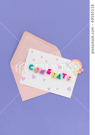 Open pink envelope with the word congrats on violet background Open pink envelope with the word congrats on violet background 69593118
