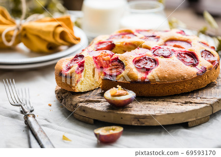Close up of traditional homemade plum cake or pie with summer table setting 69593170