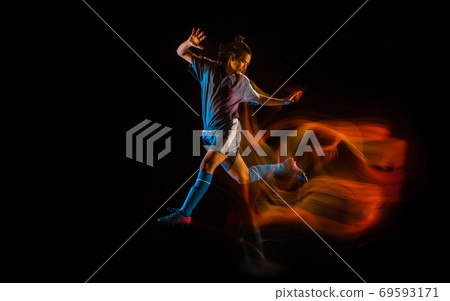 Football or soccer player on black background in mixed light, fire shadows 69593171
