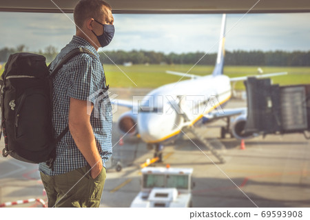 Man with a backpack waiting for departure in Covid19 time 69593908