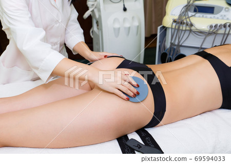 Myostimulation of the mouse on the buttocks. Myostimulation of the mouse on the buttocks. 69594033