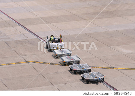 Bangkok Thailand-April 14,2019 Airport cargo and freight handling truck moving across the apron Bangkok Thailand-April 14,2019 Airport cargo and freight handling truck moving across the apron 69594543