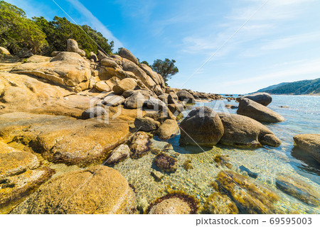Rocks in Cala Pira shore Rocks in Cala Pira shore 69595003