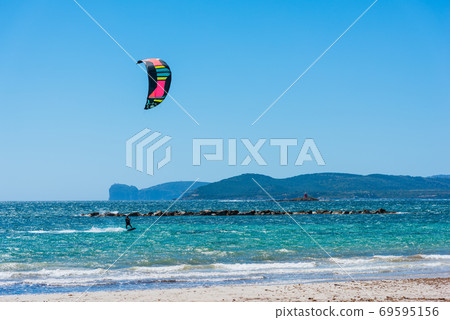 Kite surfer with Capo Caccia on the background Kite surfer with Capo Caccia on the background 69595156