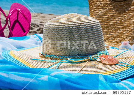 hat and flip flops on the beach hat and flip flops on the beach 69595157
