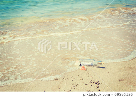Bottle with message on the foreshore 69595186