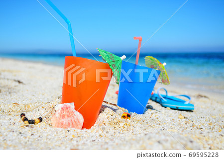 colorful drinks on the sand 69595228