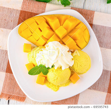 Mango ice cream sorbet with mint leaves Mango ice cream sorbet with mint leaves 69595743