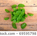 Fresh mint leaves on wooden background 69595798