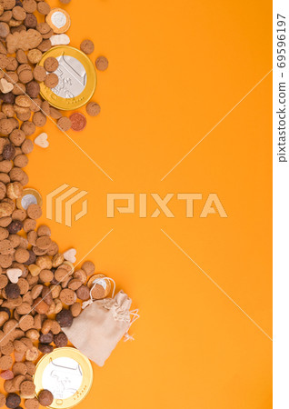 St. Nicholas Day background. Card. Dutch holiday Sinterklaas flat lay with gifts, pepernoten St. Nicholas Day background. Card. Dutch holiday Sinterklaas flat lay with gifts, pepernoten 69596197