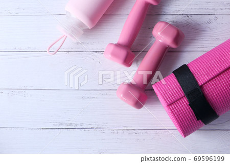 pink color dumbbell, exercise mat and water bottle on white background  69596199
