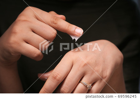 woman applying beauty cream onto skin at home woman applying beauty cream onto skin at home 69596245
