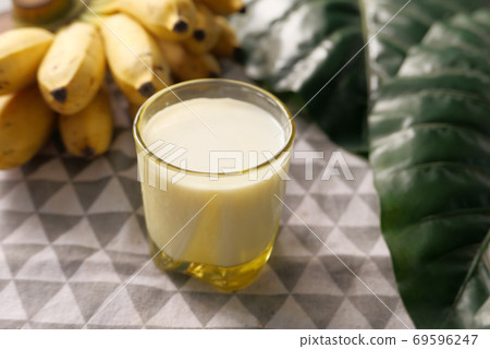 glass of milk and banana on table at morning glass of milk and banana on table at morning 69596247