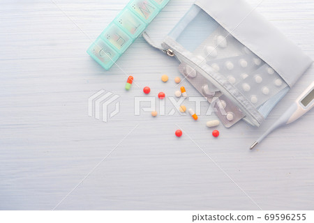 top view of colorful pills , blister pack, thermometer on table top view of colorful pills , blister pack, thermometer on table 69596255