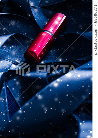 Red lipstick on blue silk and shiny glitter background, luxury make-up and beauty cosmetic 69596271