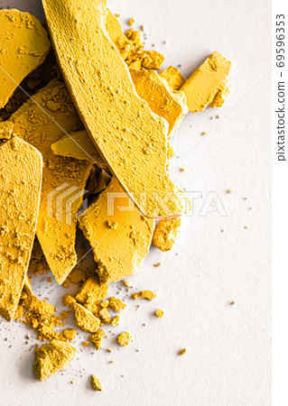 Yellow eye shadow powder as makeup palette closeup isolated on white background, crushed cosmetics and beauty texture Yellow eye shadow powder as makeup palette closeup isolated on white background, crushed cosmetics and beauty texture 69596353