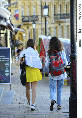 Girls walking down the street, buildings on a background. Andreevsky descent, Kyiv, Ukraine 69597823