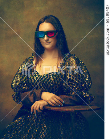 Young woman as Mona Lisa on dark background. Retro style, comparison of eras concept. 69599407