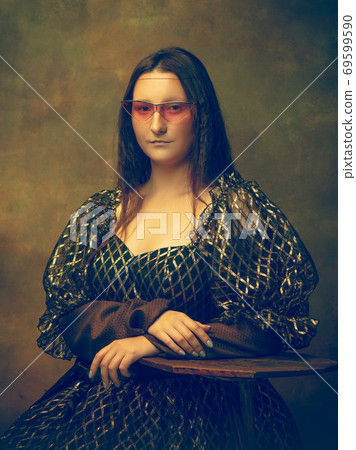 Young woman as Mona Lisa on dark background. Retro style, comparison of eras concept. 69599590