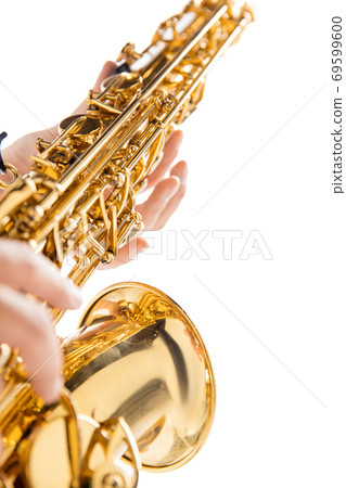 Close up woman playing saxophone isolated on white studio background 69599600