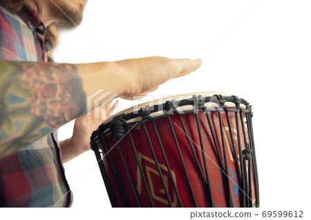 Man plays ethnic drum darbuka percussion, close up musician isolated on white studio background 69599612