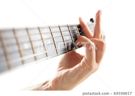 Close up of guitarist hand playing guitar, copyspace, macro shot Close up of guitarist hand playing guitar, copyspace, macro shot 69599657
