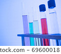 The test tube has a multicolored liquid inside. Put on a table for science experiments, color tones. close-up and selective focus. 69600018