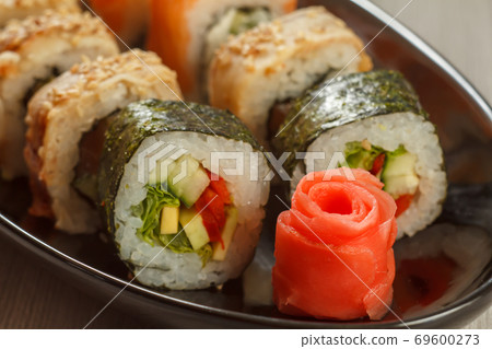 Close up pickled ginger in the form of red rose and sushi rolls Close up pickled ginger in the form of red rose and sushi rolls 69600273