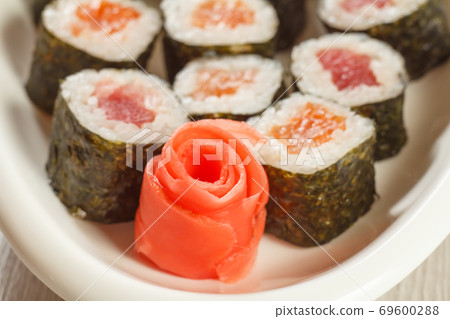Close up Hosomaki mono rolls. Sushi rolls with nori, rice and salmon Close up Hosomaki mono rolls. Sushi rolls with nori, rice and salmon 69600288