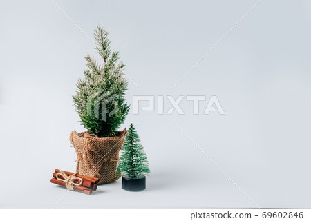 Winter layout with a small Christmas tree on a blue background Winter layout with a small Christmas tree on a blue background 69602846
