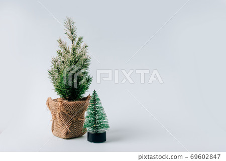 Winter layout with a small Christmas tree on a blue background Winter layout with a small Christmas tree on a blue background 69602847