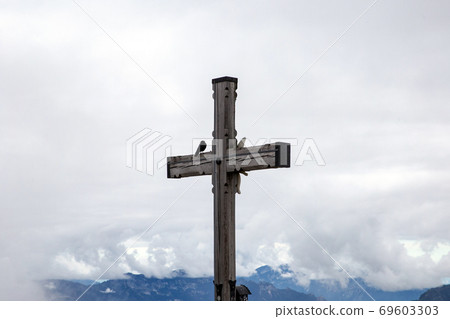 Misty landscape of Alpine Cross for travelers in the Bavarian Alps close to Hitler's Eagles Nest and the German village of Berchtesgaden, Cross of Kehlstein 69603303
