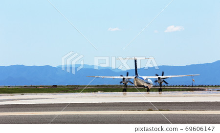 Airplane before takeoff swaying in the heat of midsummer 69606147