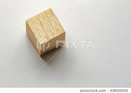 Wood cube with a soft shadow on grey table 69608009