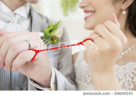 A bride and a bride connected by a red thread A bride and a bride connected by a red thread 69609545
