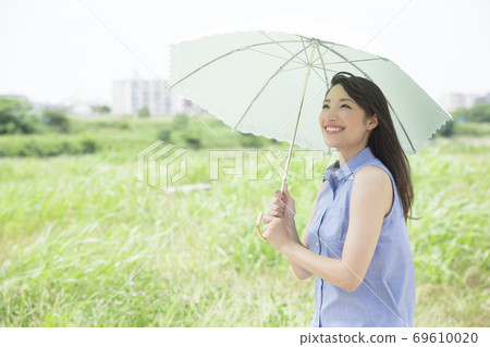 A woman holding a parasol 69610020