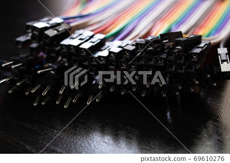 Multicolored computer wires on a black background Multicolored computer wires on a black background 69610276
