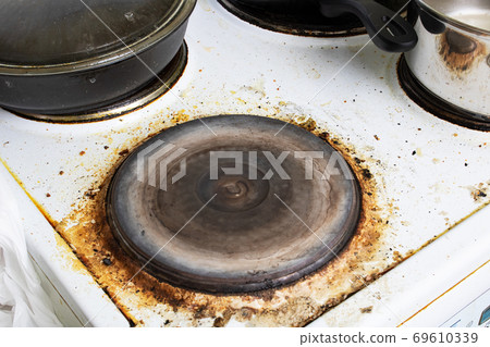 Dirty electric stove close up, house cleaning 69610339