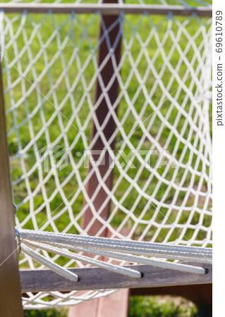 Grid rope as part of hammock. Vacation and summer time Grid rope as part of hammock. Vacation and summer time 69610789