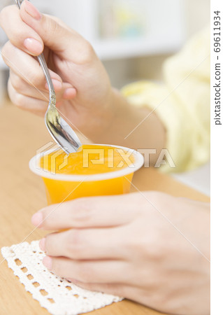 A woman eating jelly A woman eating jelly 69611934