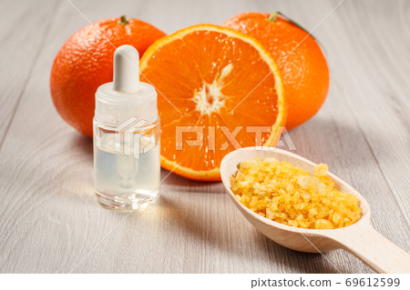 Cut orange with two whole oranges, bottle with aromatherapy oil 69612599