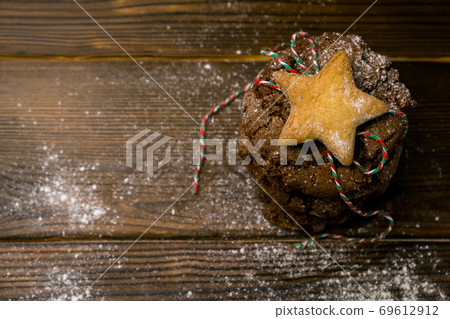 Christmas cookies with festive decoration on wooden table Christmas cookies with festive decoration on wooden table 69612912